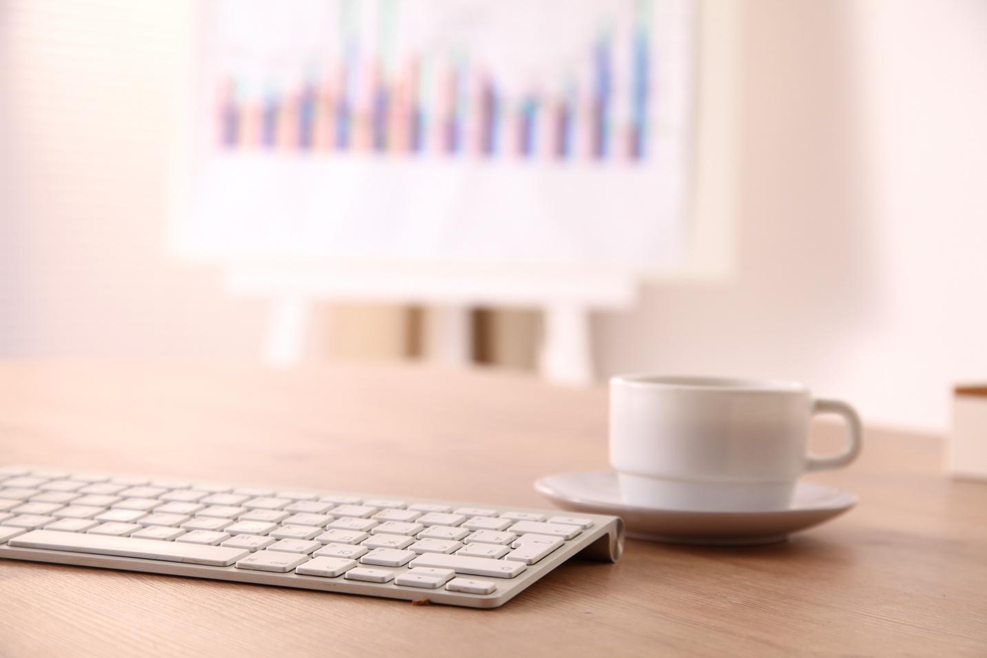 office desk with a computer and  cup of coffee